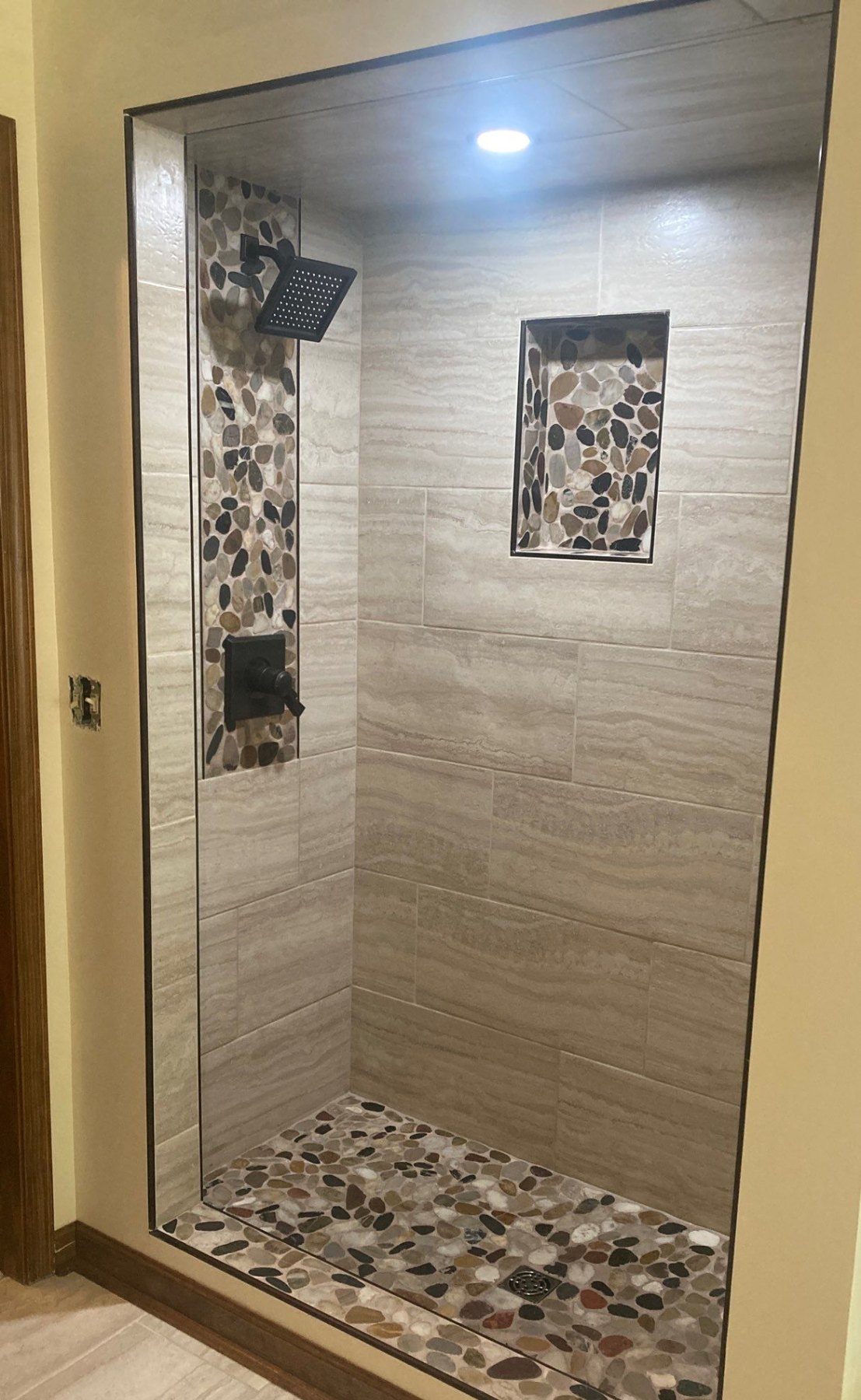 Custom tile shower with built-in niche by Crain Bros Inc in Northeast Arkansas
