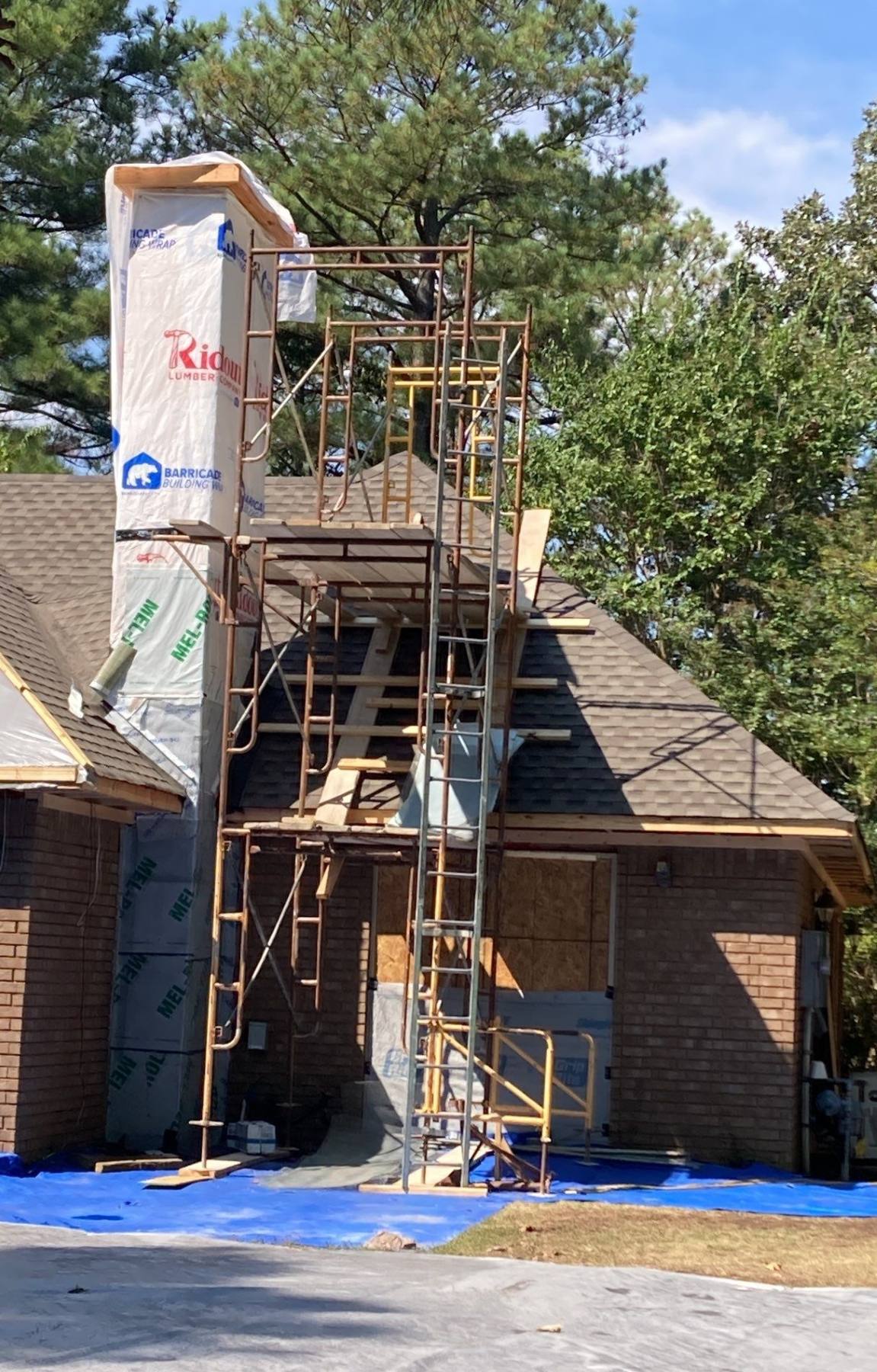 Chimney enclosure reconstruction with new sheathing, weather barrier, roof access, and scaffolding