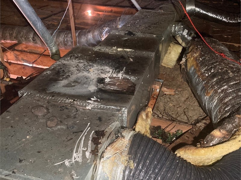 Fire and smoke damage affecting HVAC equipment, ductwork, insulation, and surrounding attic materials
