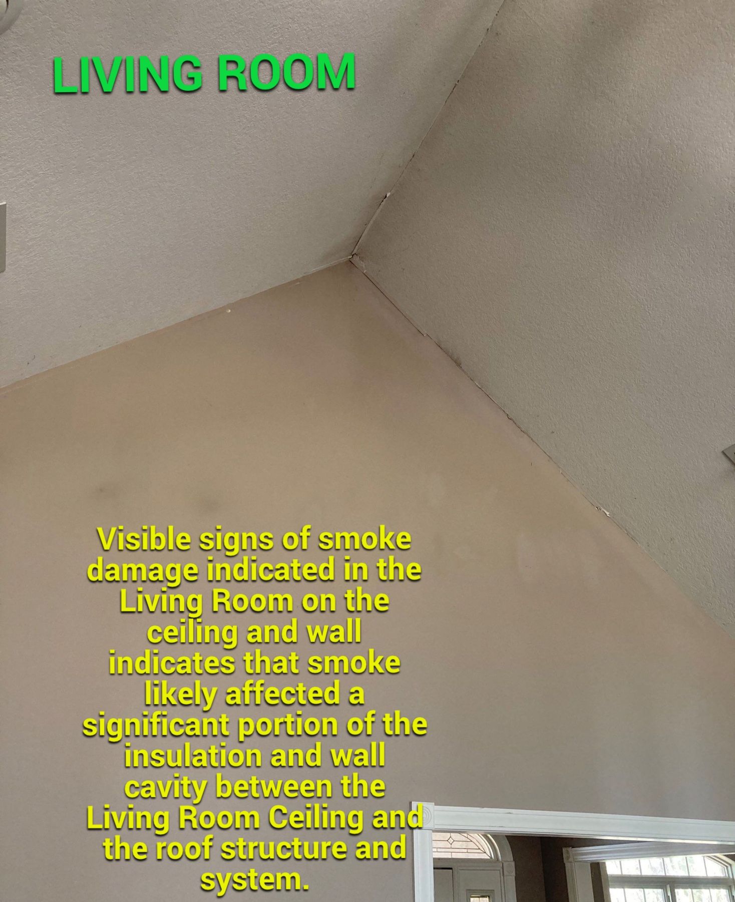 Visible smoke residue at a living room wall and ceiling connection indicating the need to inspect concealed cavities