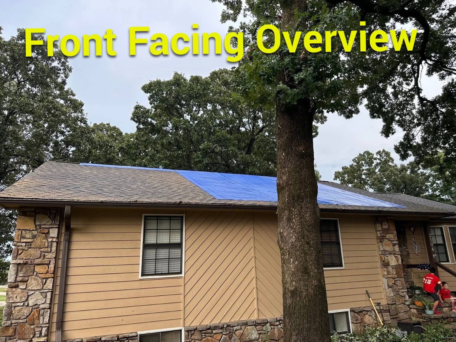 Temporary roof tarping protecting a fire-damaged property from additional weather exposure