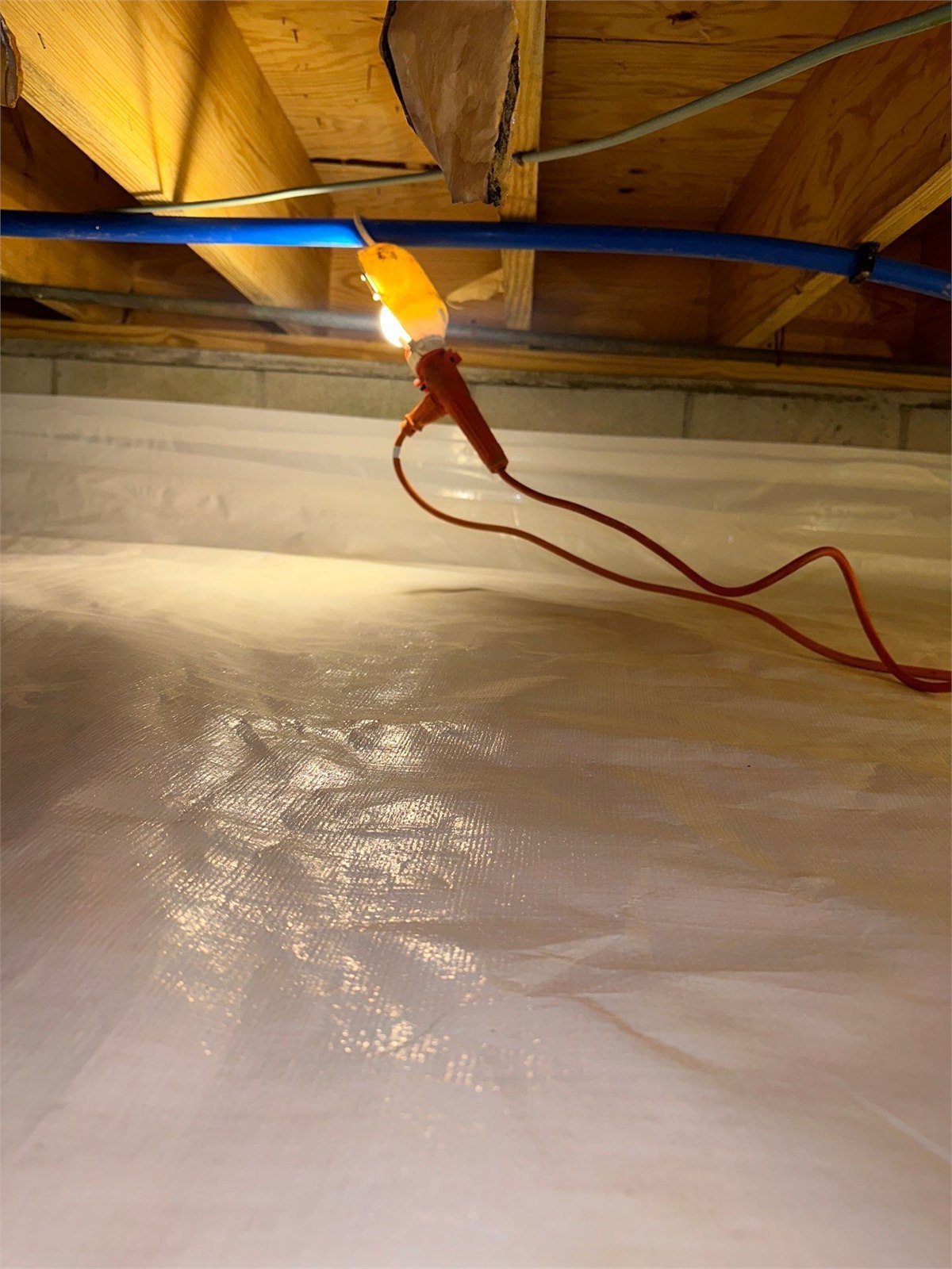 Crawlspace encapsulation liner installed across the crawlspace floor and foundation surfaces