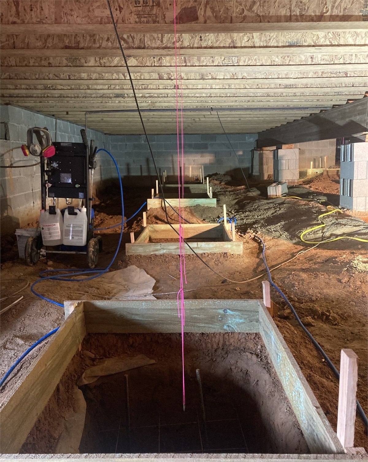 New pier foundation supports installed for structural correction and house leveling, photograph 1