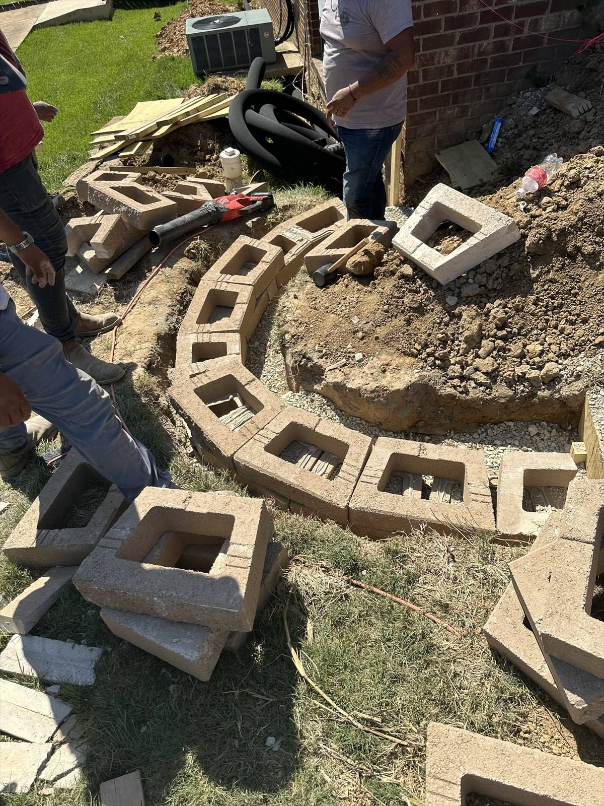 Retaining wall construction process at a Northeast Arkansas property, photograph 1