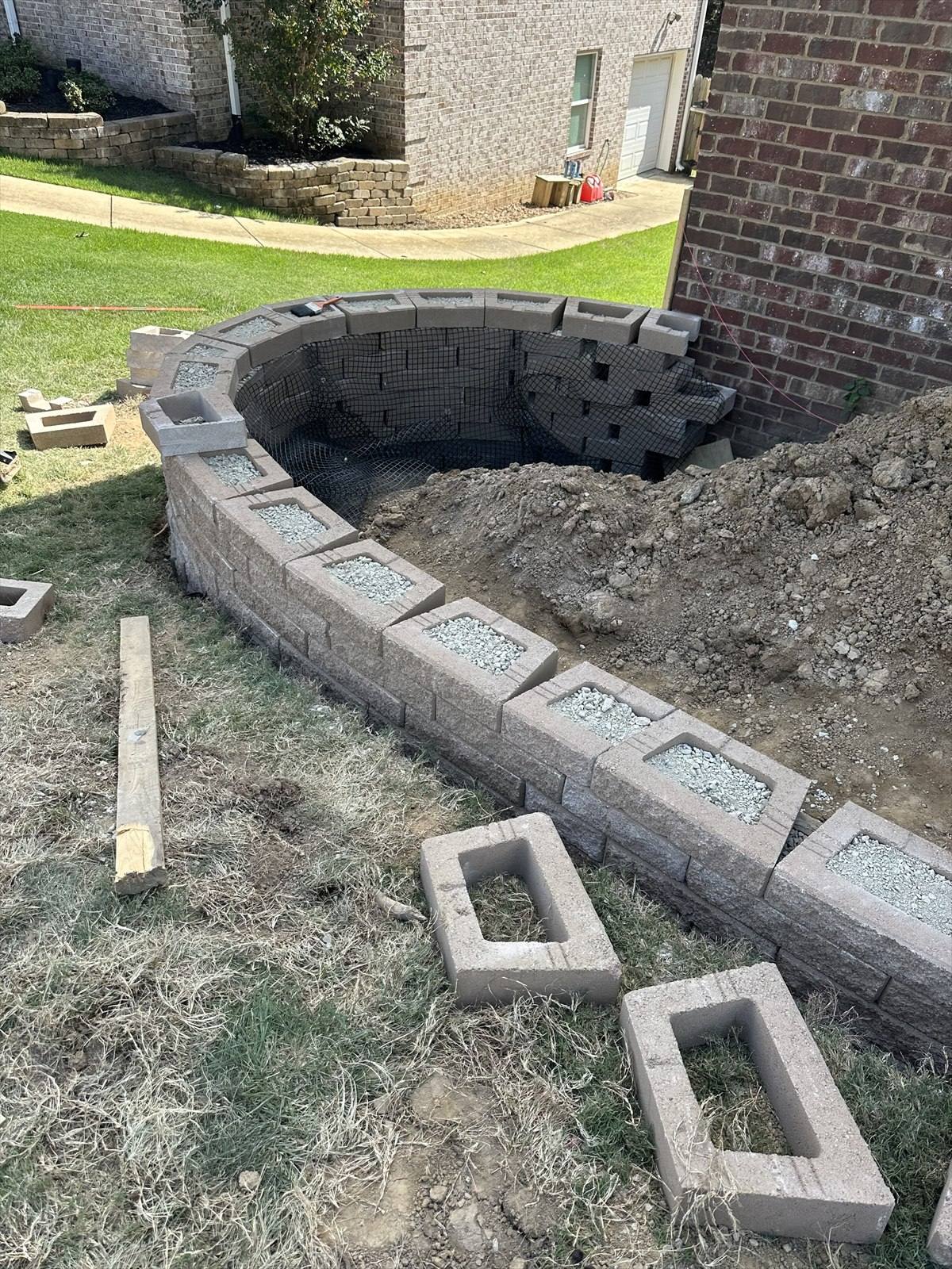 Retaining wall construction process at a Northeast Arkansas property, photograph 2