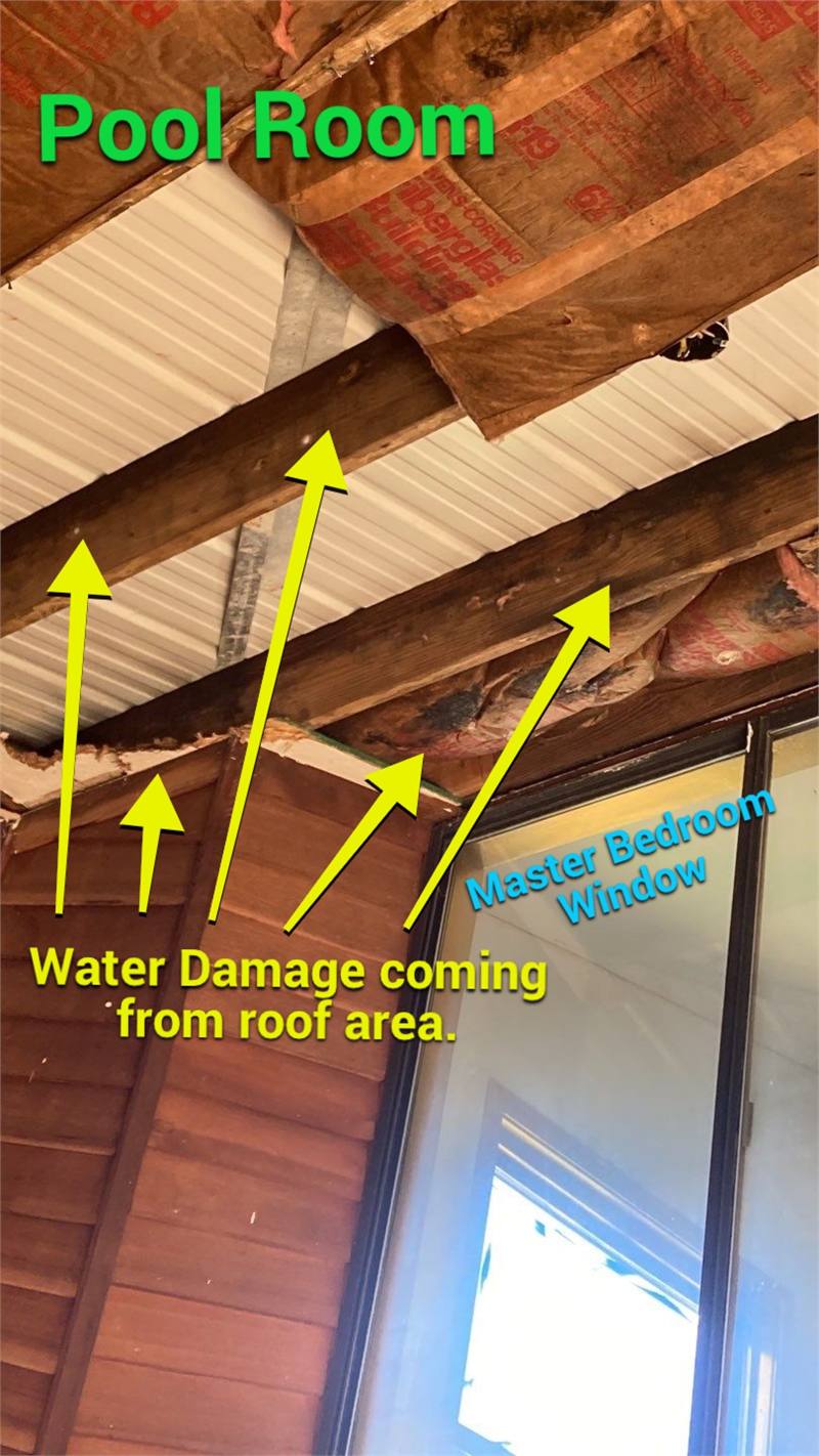 Annotated exposed framing showing documented water-damage paths from a roof area