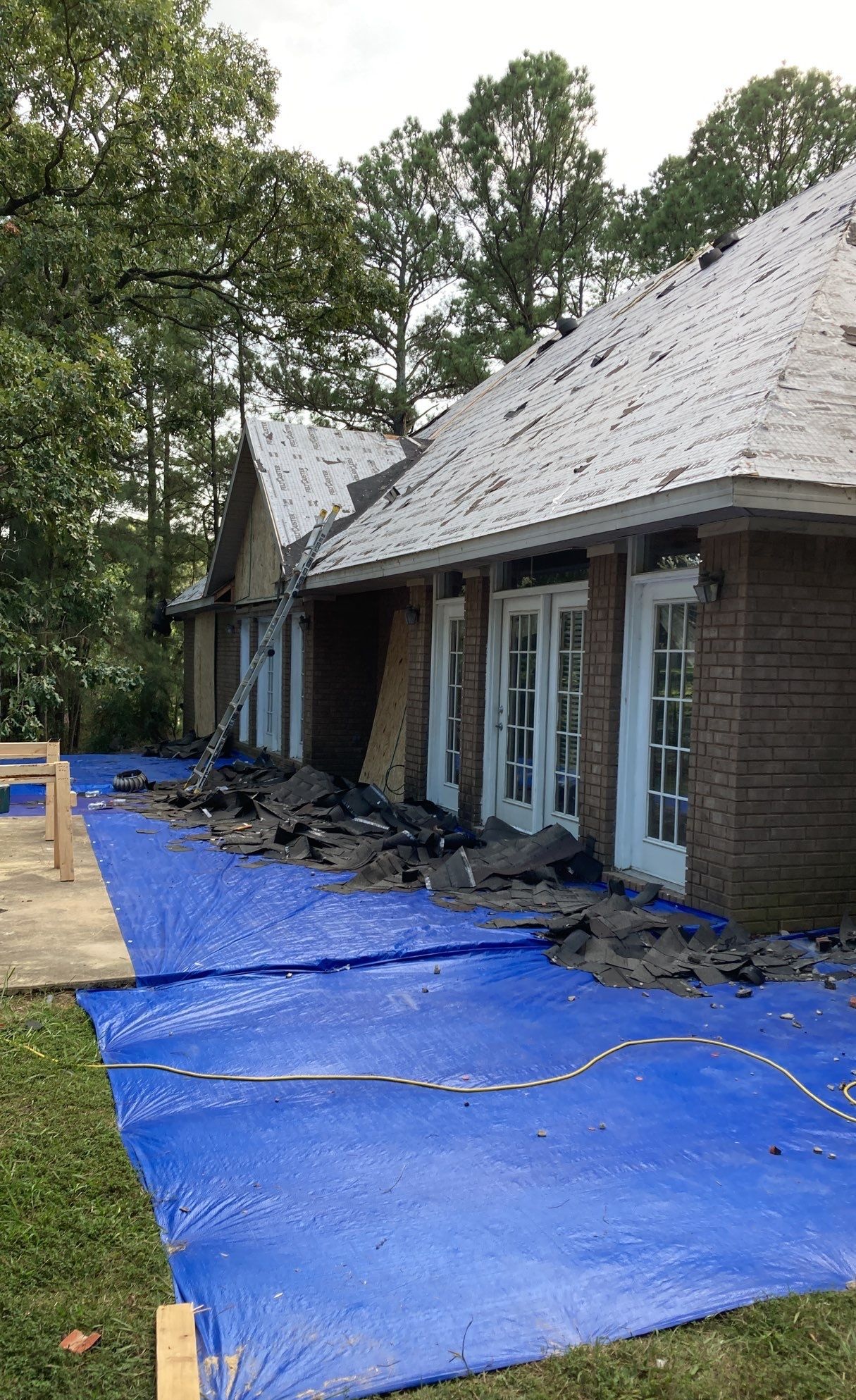Removal of roofing materials to expose fire damage within the roof system in Northeast Arkansas.