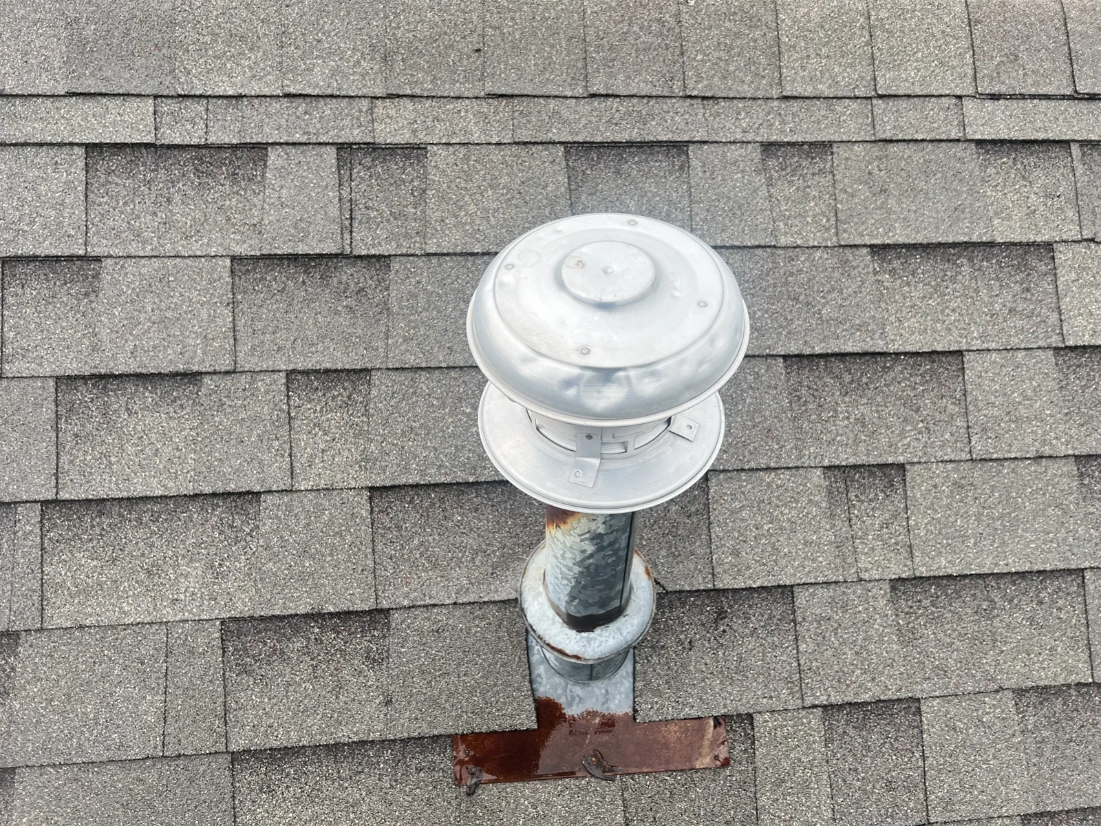 Hail impact dents on a metal roof vent in Northeast Arkansas.