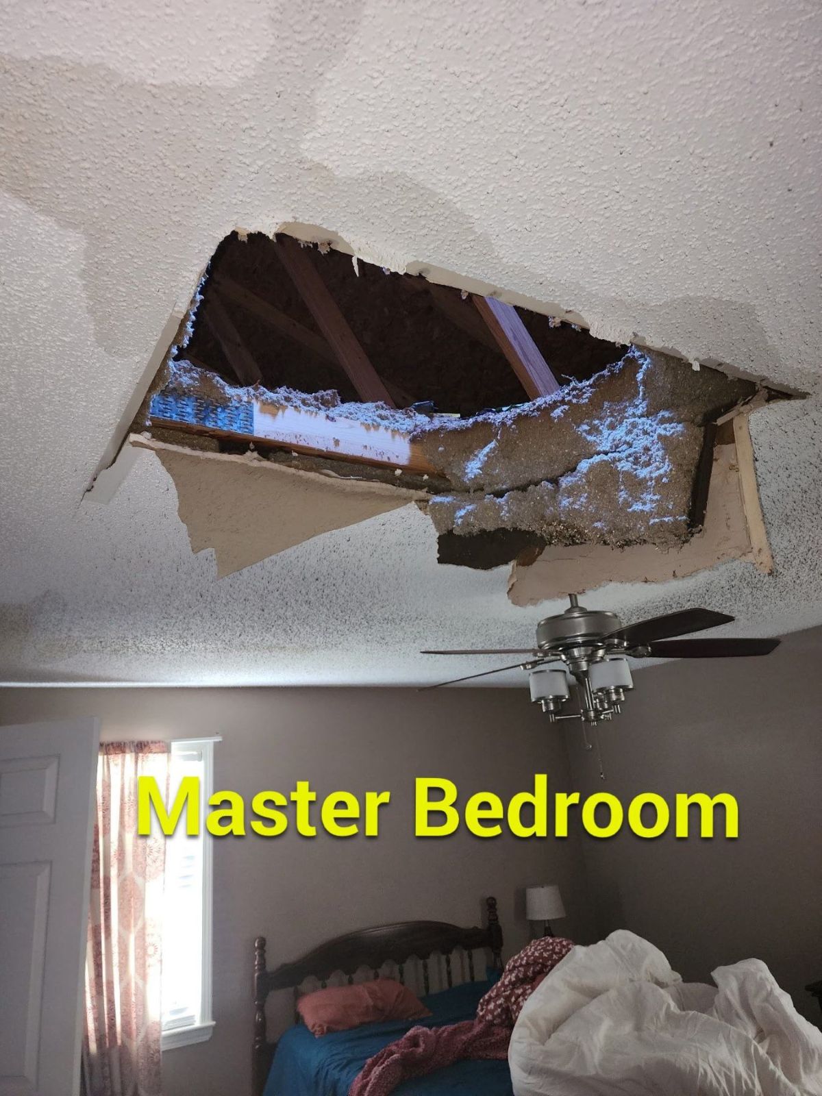 Interior ceiling and room damage below a storm-created opening in the roof
