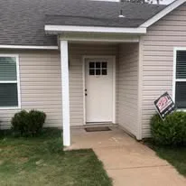 Same tornado-damaged house after complete restoration